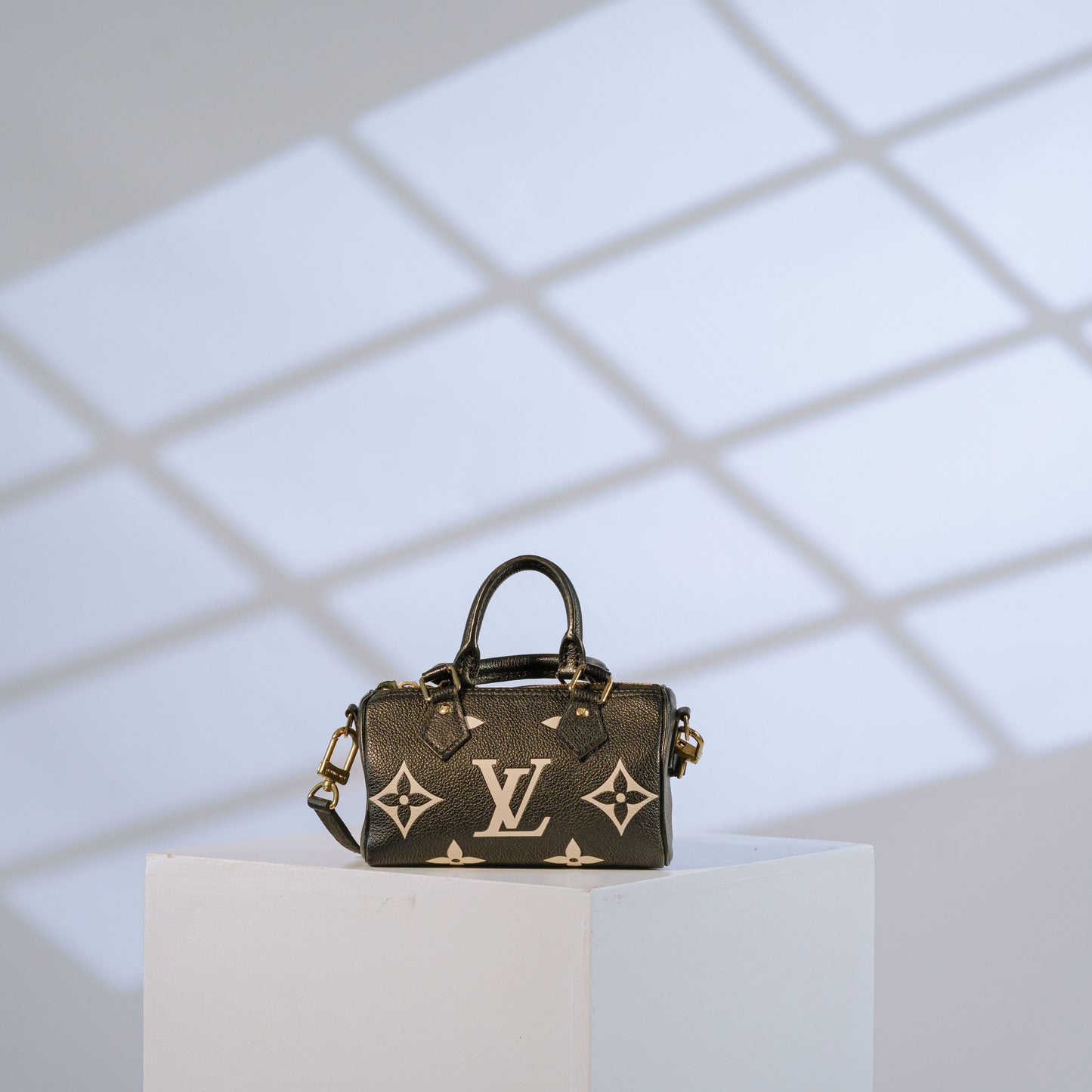 Louis Vuitton Nano Speedy in black Monogram Empreinte leather with cream monogram and gold-tone hardware