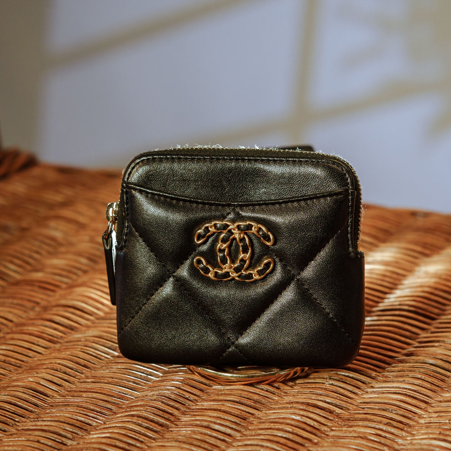 Chanel black leather coin purse with gold braided CC logo and zipper, includes Chanel box