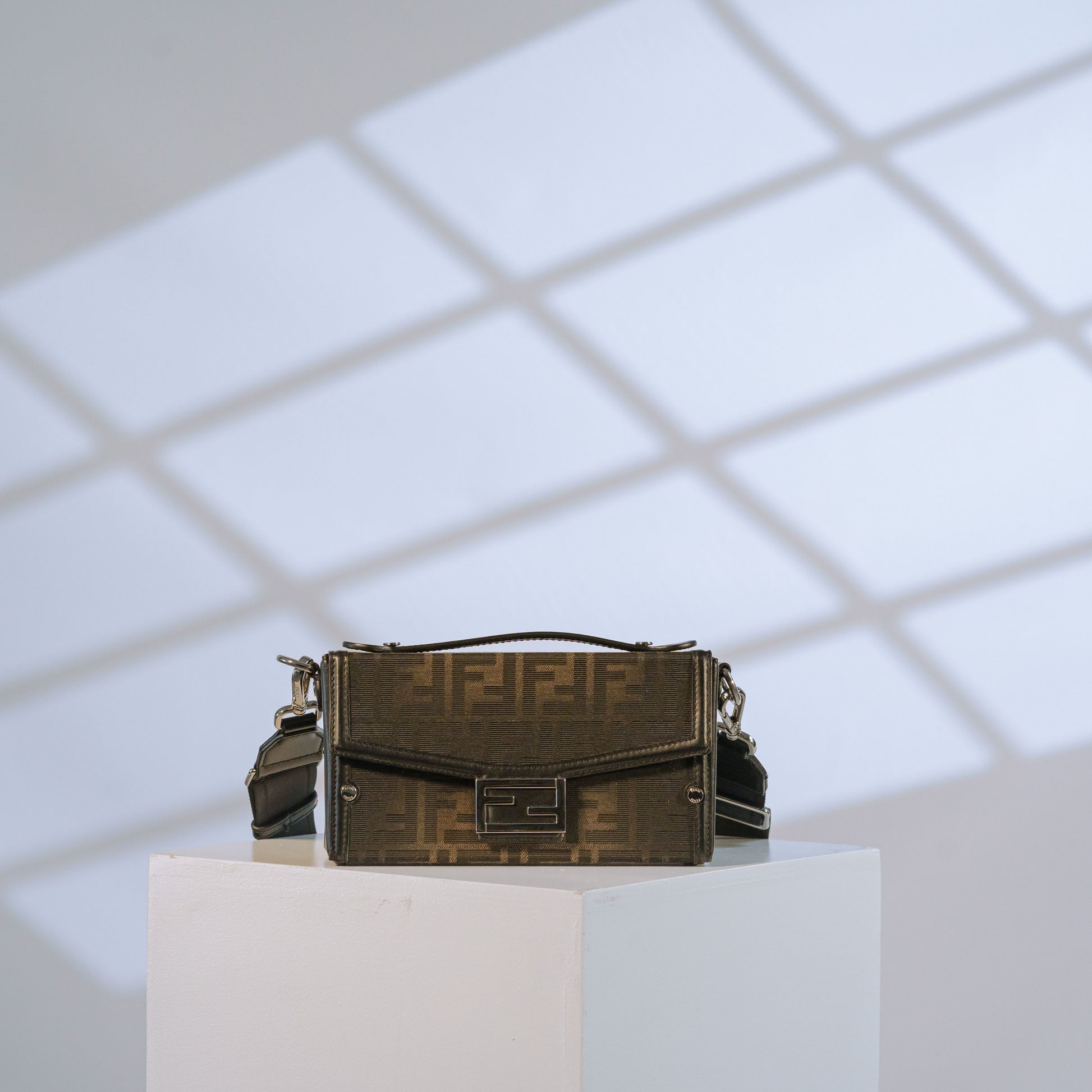 Fendi Zucca print mini crossbody bag with black leather trim and silver hardware, front view
